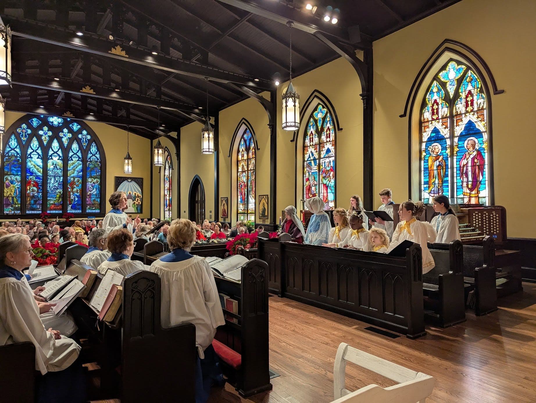 The St. Luke's sanctuary filled with choir members, worshipers, and stained glass